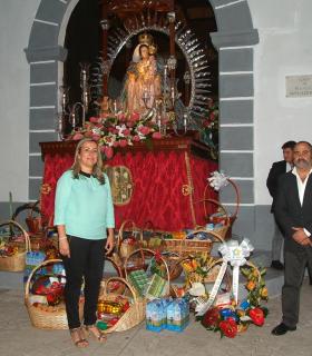 Cientos de vecinos de Machado y de todo el municipio participan en la ofrenda floral y de alimentos por el Día de la Virgen del Rosario. · foto 3